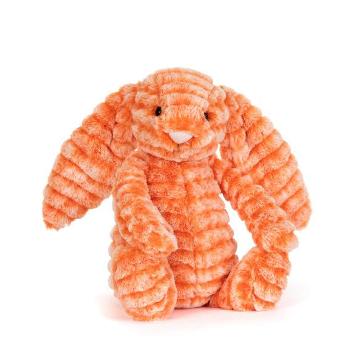 An orange plush bunny toy with a ribbed, corduroy-like texture, sitting against a plain white background.