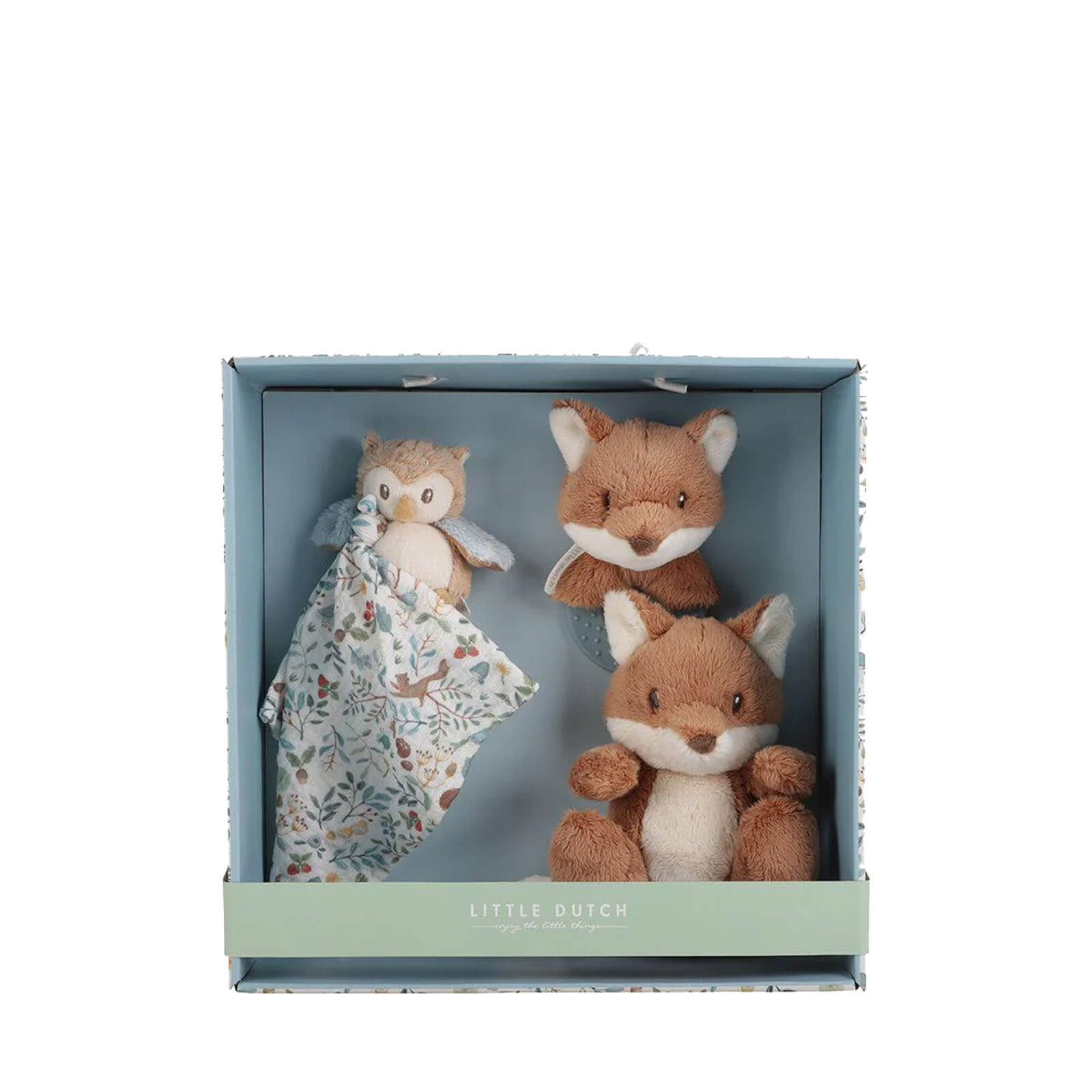 A gift box open to reveal a plush owl, a plush fox, and a teething ring with a floral pattern, all displayed on a blue background.
